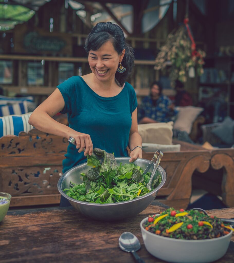 Post-HerbFest MASTERCLASS in 5 Element Nutrition. Learn how to use food as medicine with this ancient chinese medicine wisdom. Image is of Kimberly Ashton stirring a salad. Natural Health workshop | Everyday Empowered