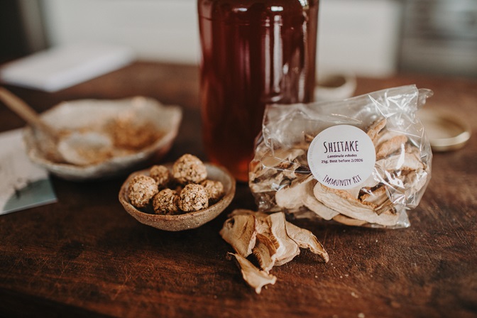 Image of packet of shiitake mushrooms and shiitake honey pearl with jar of honey in the background- recipe from the DIY Immunity Remedy Kit. Learn herbal medicine simply and easily and learn the medicinal benefits of shiitake mushroom. Everyday Empowered