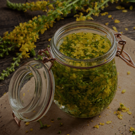 picture of jar wtih yellow flowers and leaves in it - herbal medicine workshop on the Sunshine Coast, making tinctures, elixirs, glycetracts and vinegars.