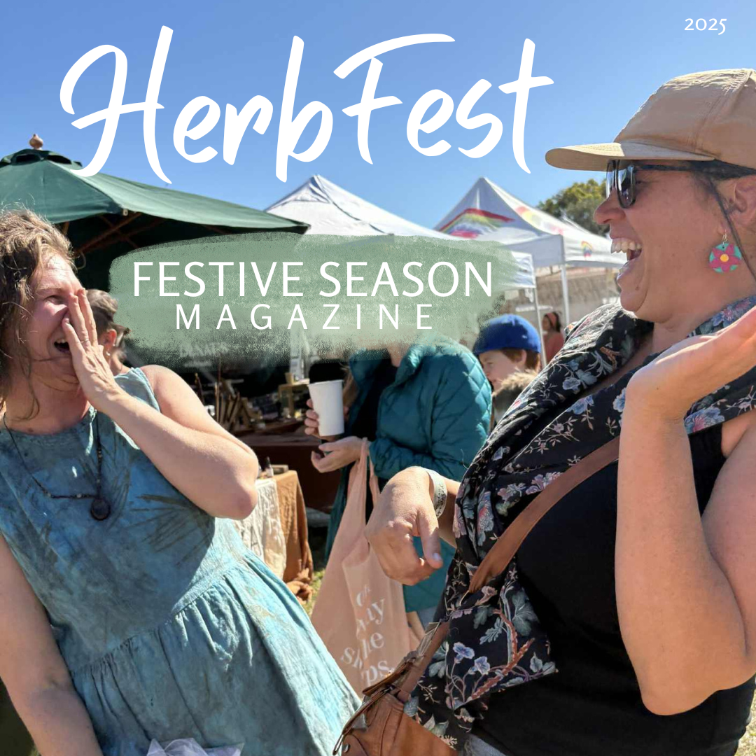 Image of two women laughing at community herbal medicine event HerbFest on the Sunshine Coast, with words HerbFest Festive Season Magazine 2025.