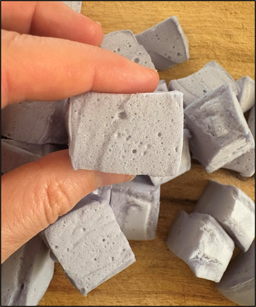 herbal marshmallow recipe. Image of fingers squeezing homemade nourishing herbal marshmallow
